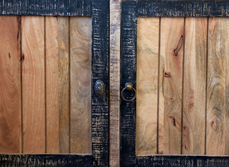 Old-fashioned wooden drawer bronze handles -part of an old wardrobe