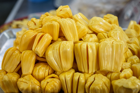 Extracted flesh jackfruit in bright yellow color selling on metal tray in local market with blurred background, Angsila, Chonburiの写真素材