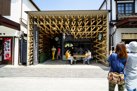Dazaifu, Japan - May 14, 2017 :Tourists taking photo of iconic Starbucks coffee store in Dazaifu, design by Kengo Kuma.のeditorial素材