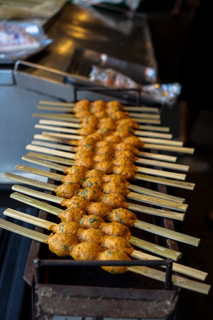 Grilled spicy fish cake or dried Janglon, Chonburi local food, on open metal stove in Nongmon market, Chonburi, Thailandの写真素材