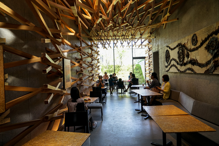 Dazaifu, Japan - May 14, 2017 :Interior design decoration by woven cedar wood of iconic Starbucks coffee store in Dazaifu with customers, design by Kengo Kuma, famous Japanese architect, Dazaifu, Fukuoka, Kyushu, Japanのeditorial素材