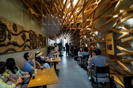 Dazaifu, Japan - May 14, 2017 :Interior decoration, natural light atmosphere of iconic Starbucks coffee store in Dazaifu with woven cedar wood full of customers, design by Kengo Kuma, famous Japanese architect, Dazaifu, Fukuoka, Kyushu, Japanのeditorial素材