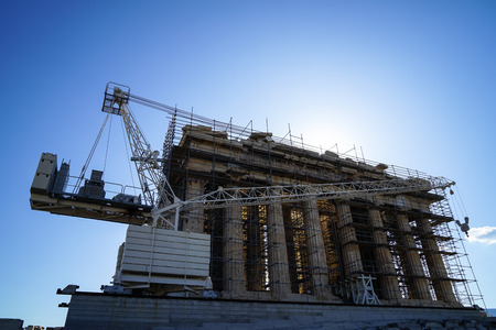 Restoration work in progresson top of Acropolis with machine crane, scaffolding and blue sky background, Athens, Greeceのeditorial素材