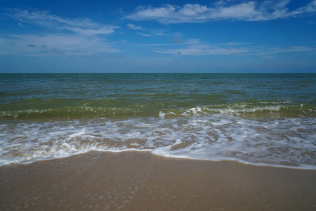 Soft foam slow sea wave on white sand beach with blue sky and white cloud background, Samila beach, Songkhla, Thailandの写真素材