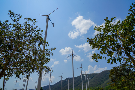 Windmill turbines white steel post technology to generate clean renewable ecological energy with...