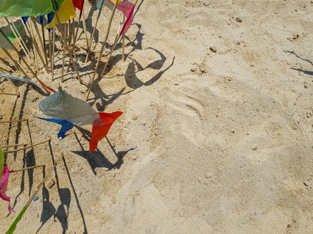 Colorful triangle paper flags stick on sand background with copyspace for making traditional sand pagoda on Sonkran festival, Bangkok, Thailandの写真素材