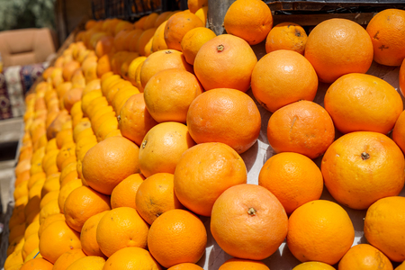 Pile of fresh natural organic orange fruit background in orange color and marked skin texture selling in fruit juice shop, Cappadocia, Turkeyの写真素材