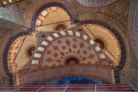 Istanbul, Turkey - May 26, 2018: The blue mosque interior dome ceiling beautiful ornamental decoration and lighting with historical restoration framework, selective focus, Istanbulのeditorial素材