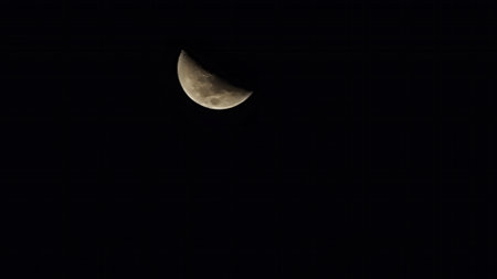 Crescent moon in the night sky, close-up view.の写真素材