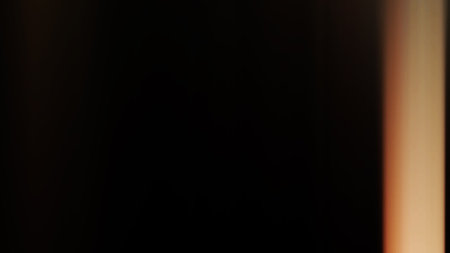 blurred light trails on black background, abstract motion blur background.