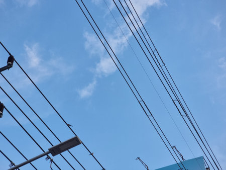 electricity post with blue sky and white cloud background, power line