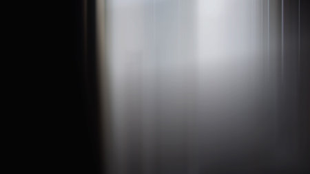 Abstract vertical motion blur effect. Light and shadow on black background.の写真素材