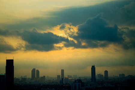 The sun in blue cloud over the Bangkok cityの写真素材