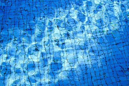 Swimming pool texture with sun lighting reflectionの写真素材