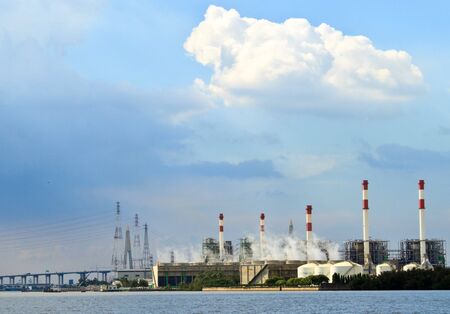 Factory, power lines, city bridge and skyの写真素材