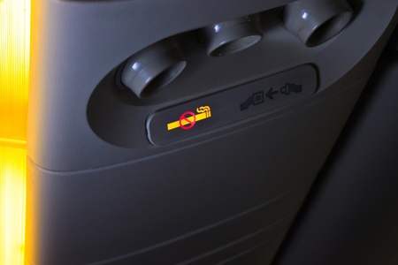 Overhead NO SMOKING sign inside an airplaneの写真素材