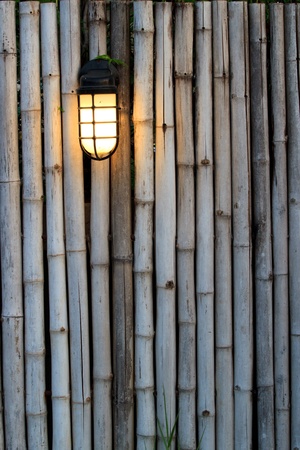 Yellow lamp on the bamboo fenchの写真素材