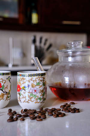 two white cups and a teapot on white counterの写真素材