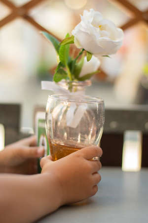 Little girl drinking iced tea on the terrace of a barの写真素材