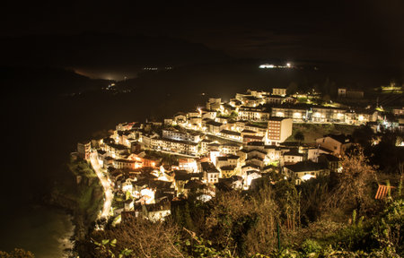 Lastres in Asturias, Spain, illuminated at nightの写真素材