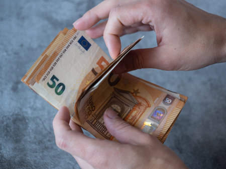 womans hands counting money. fifty euro bills. inflation. accounting. domestic economy