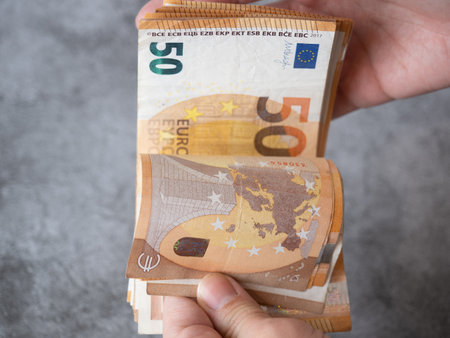 womans hands counting money. fifty euro bills. inflation. accounting. domestic economyの写真素材