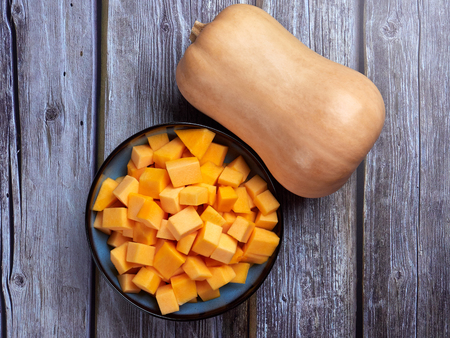 Butternut squash cubes on gray rustic backgroundの写真素材