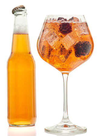 A bottle and a glass of blackberry-flavored apple cider, on a white backgroundの写真素材