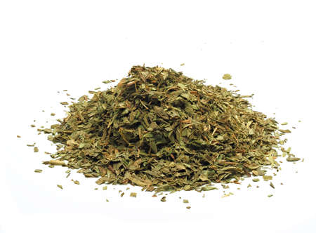 Close-up view of a heap of dried tarragon on white backgroundの写真素材
