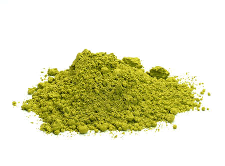Close-up view of a heap of matcha tea powder on white backgroundの写真素材