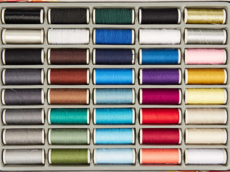 Assortment of spools with colored sewing threadの写真素材