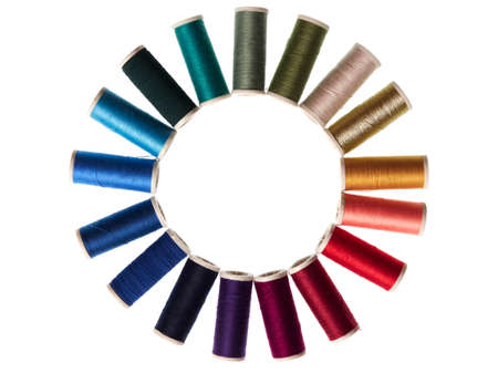 Assortment of spools with colored sewing thread on white background