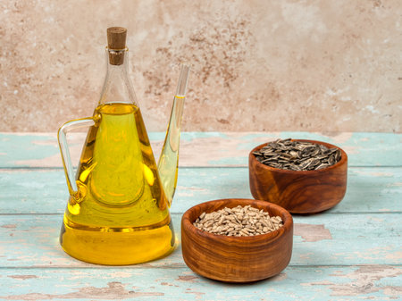 A jug of cold pressed sunflower oil on bright blue wooden backgroundの写真素材