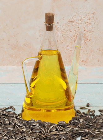 A jug of cold pressed sunflower oil on bright blue wooden backgroundの写真素材