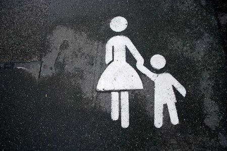 mother and child pedestrian sign painted on the roadの写真素材