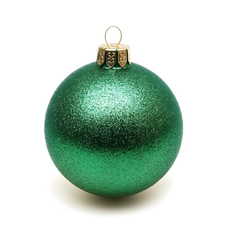 A green, shiny, sparkly Christmas ornament with a golden top.の写真素材