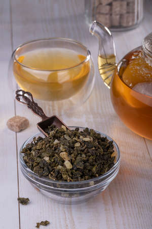 Chinese green oolong tea with fruit additives, selective focus on the cup, close-up