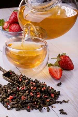 Chinese green oolong tea with fruit additives, selective focus on the cup, close-up