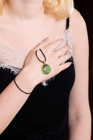 pendant on a woman's hand, beauty photography, amulet tree of life, talisman, close-upの写真素材
