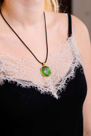 pendant amulet tree of life on a woman's neck, round talisman close-up