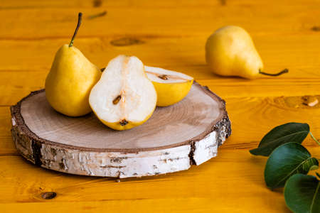 Pears cut in half lie on a wooden table close-up of macro photographyの写真素材