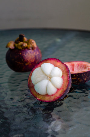 Mangosteen on a glass table. The fruit queen of Thailand is mangosteen. asian fruitsの写真素材