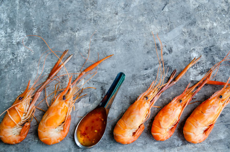 Huge boiled delicious king prawns shrimps on a gray background close-up, top view, flat lay, copy space, space for text, border on the bannerの写真素材