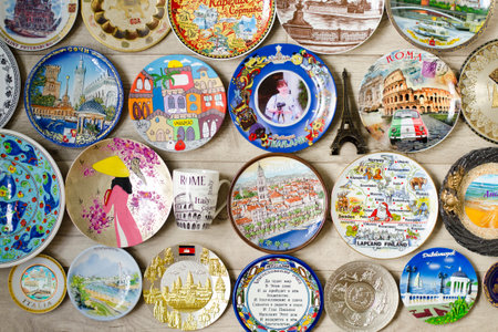 Collection of decorative souvenir wall plates from different countries Cuba, Thailand, Russia, Finland, Italy, Vietnam, Asia, Europe, Croatia, India, Israel, Turkey, Cambodia, Egypt. The concept of tourism and travel around the worldのeditorial素材