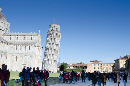 Pisa, Italy - February 2019: Tourists near the Leaning Tower of Pisa in Italy. World landmark and monument. Tourism and travel in Europeのeditorial素材