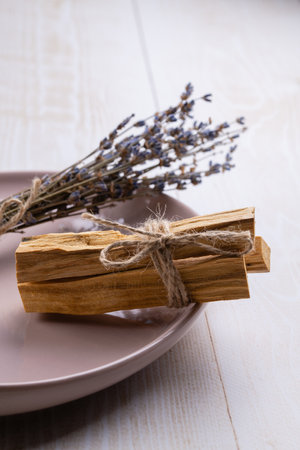 Natural incense: a bunch of palo santo sticks and a bunch of dry lavender close-up with a focus on a bunch of palo santo sticksの写真素材
