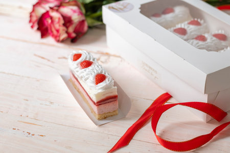 Delicious sweet cake close-up selective focus, cake with white protein cream decorated with strawberries, strawberry mousse, souffleの写真素材