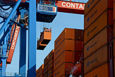 Containers being loaded on a cargo ship at the Port of Hamburg, Germany