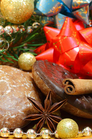 Gingerbread with icing, chocolate, star anise, cinnamon stick and christmas decorationの写真素材