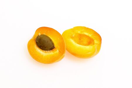 Apricots on a white cutting board made of plasticの写真素材